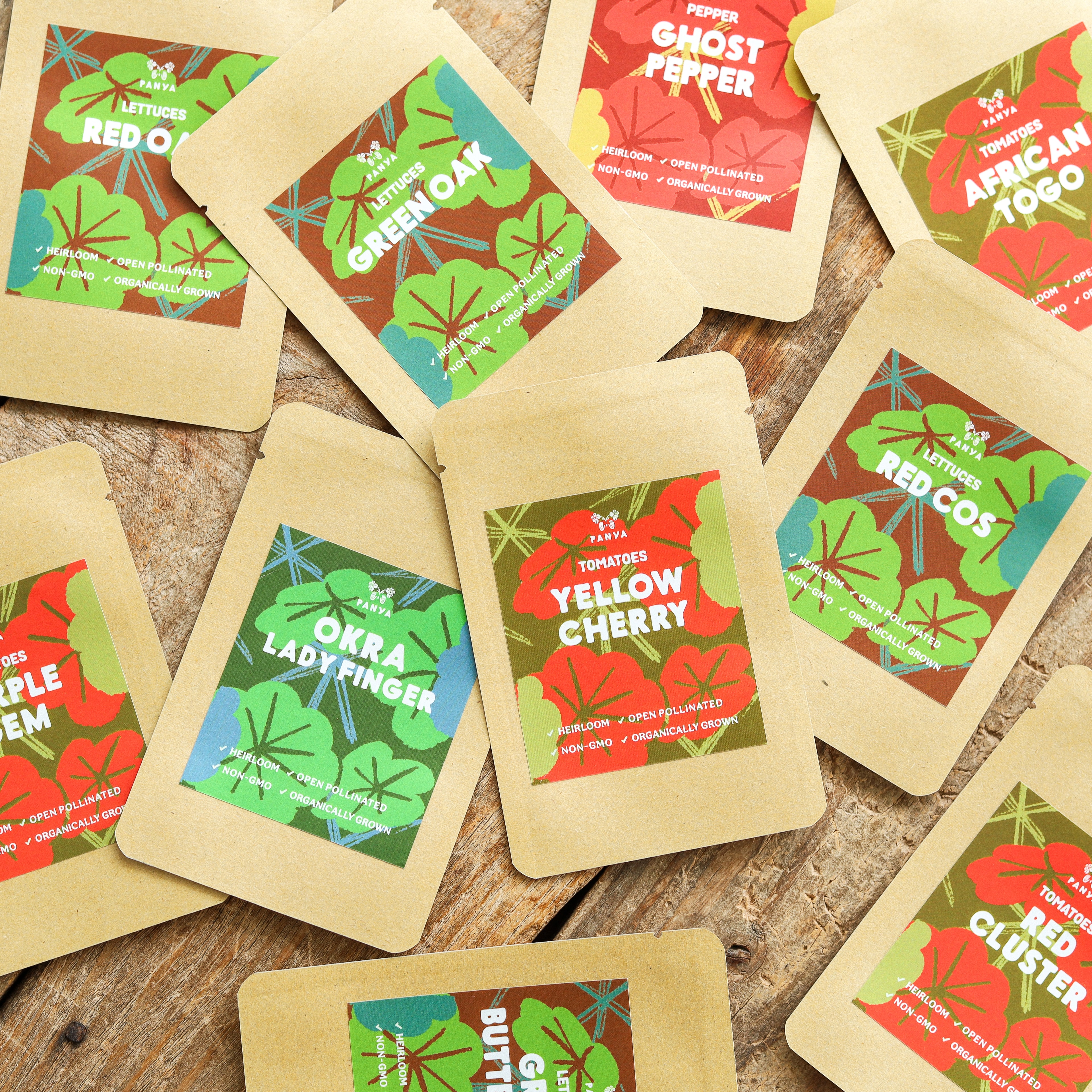 Panya seed packets with illustrated labels arranged on a wooden tabletop